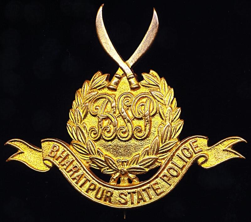 India (Princely States): Bharatpur State Police. Cap / Pagri / Turban badge. A die-cast gilding metal badge. Circa 1912-1947