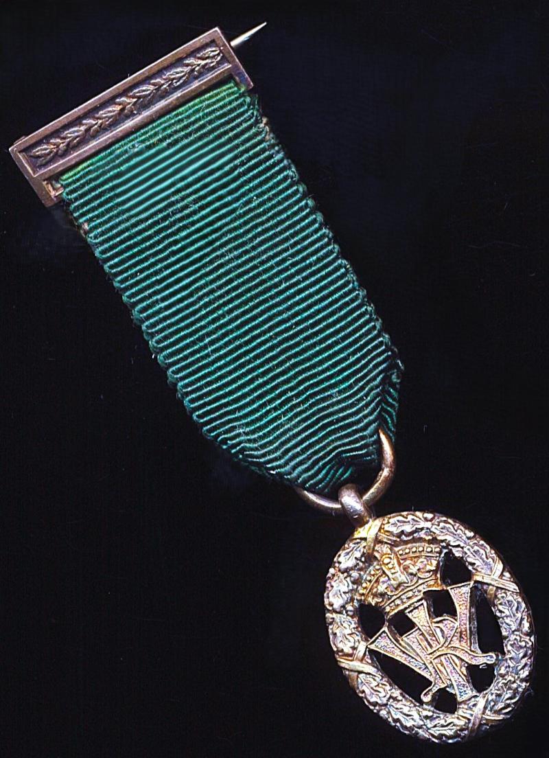 Volunteer Decoration (India and Colonies). With VRI obverse cypher and the riband complete with the integral silver top brooch bar (with pin and clasp fittings)
