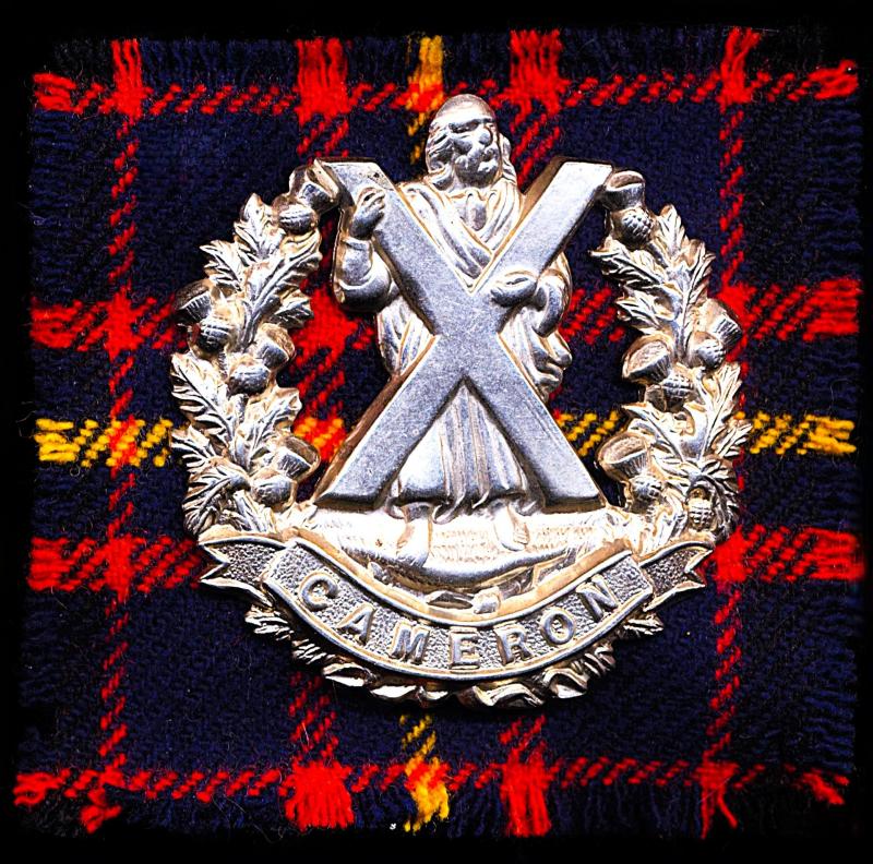 Queens Own Cameron Highlanders. Cap Badge. White-metal with 'Cameron' scroll. Circa 1914-1953