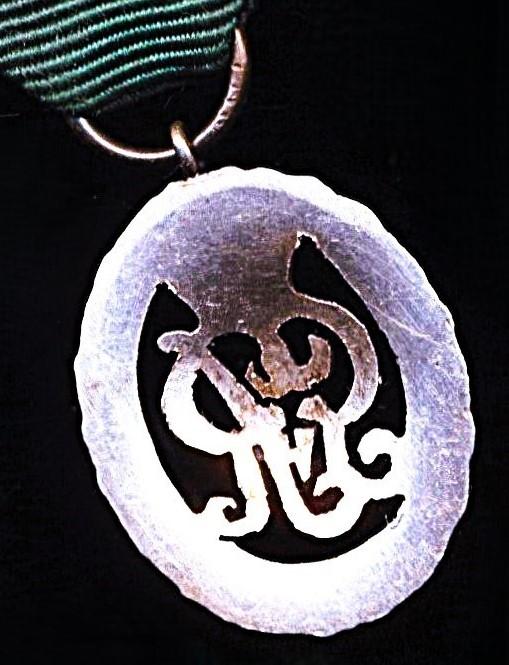 United Kingdom: Volunteer Decoration. With GV obverse cypher and the riband complete with the integral silver top brooch bar (with pin & clasp fittings).