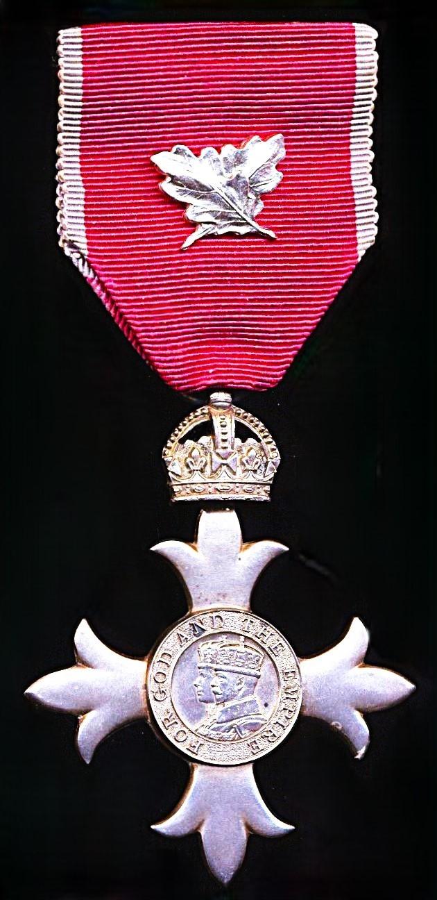 Member of the Order of the British Empire (Civil Division). M.B.E. 2nd type breast badge, with silvered 'Oakleaves' emblem for Gallantry on riband