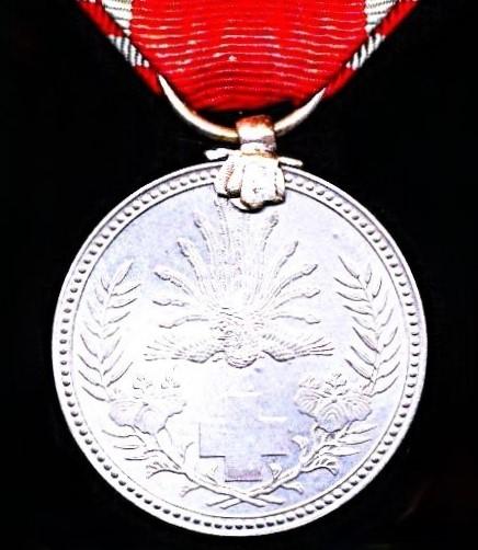 Japan (Showa era): Red Cross Society. Pre 1941 Silvered 'Special Life Members' medal. With silk rosette on riband