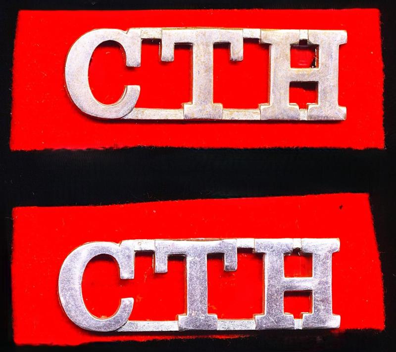 Union of South Africa (1910-61): Cape Town Highlanders. Pair of white-metal regimental shoulder title badges on 'Red Oath' flashes. Circa 1939-1945
